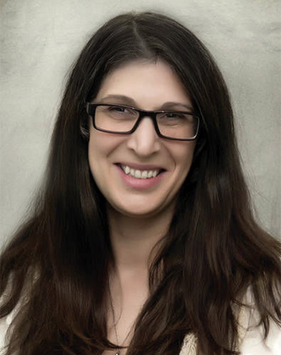 B.Balsamo-web Shoulder-up shot of a woman with long brown hair and glasses