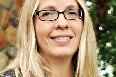 Blonde woman with long hair and glasses