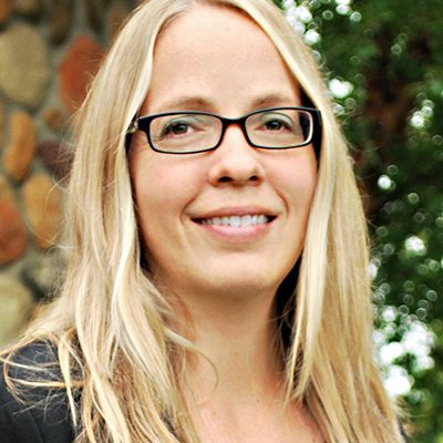 JWilliams_web Blonde woman with long hair and glasses