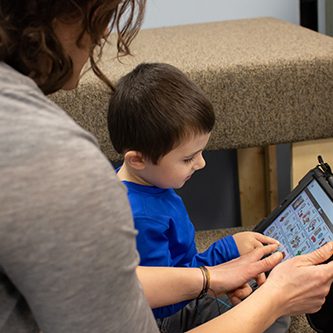 OT1_web Woman using an Ipad with a young boy