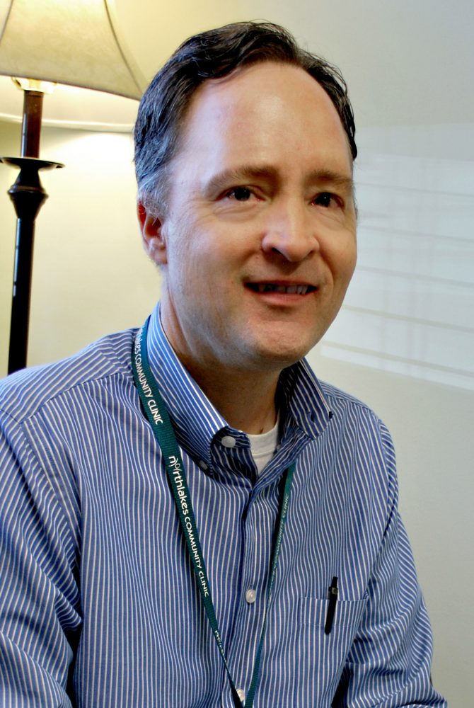 TJoseph_007 Man smiling with brown hair and striped long sleeve shirt