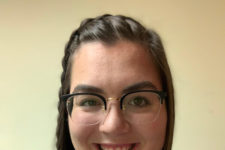 Smiling photo of woman with brown hair and glasses