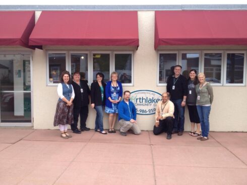 Nine staff members posed outside of Turtle Lake Clinic