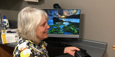 Blood-Pressure-Monitoring_web Female provider smiling and holding blood pressure cuff