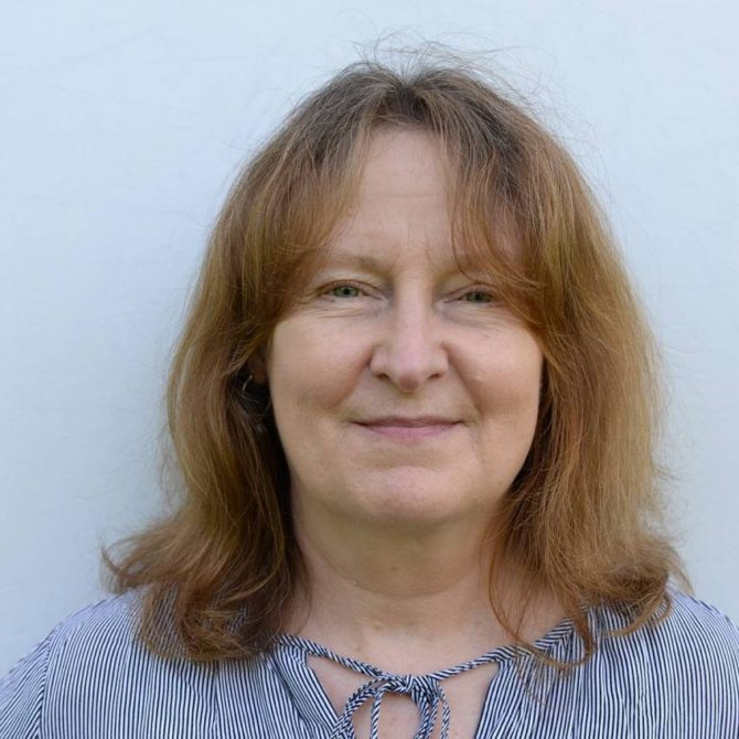 Woman with shoulder length hair and striped shirt