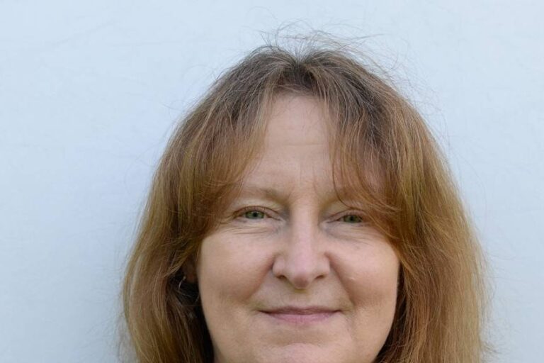 Woman with shoulder length hair and striped shirt
