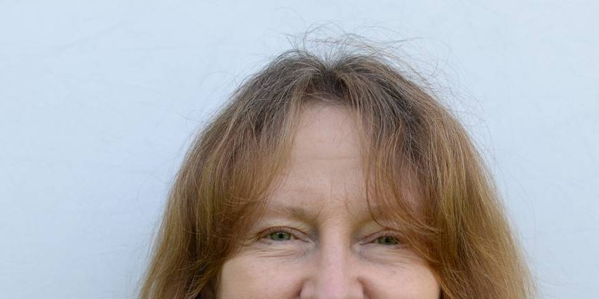 Woman with shoulder length hair and striped shirt