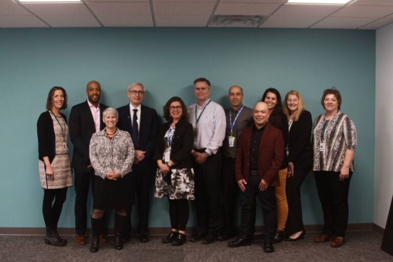 Staff members smiling with Tony Evers in Ashland Clinic