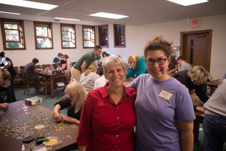 Reba rice smiling with a woman at an advocacy meeting