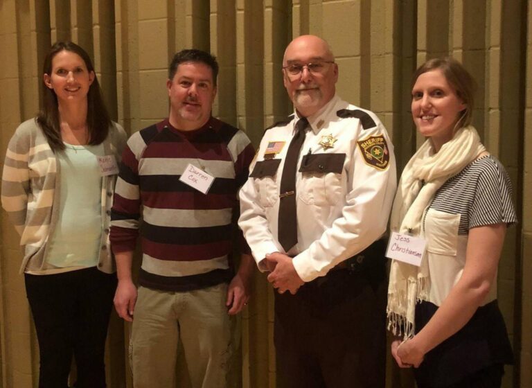NorthLakes staff smiling with a police officer