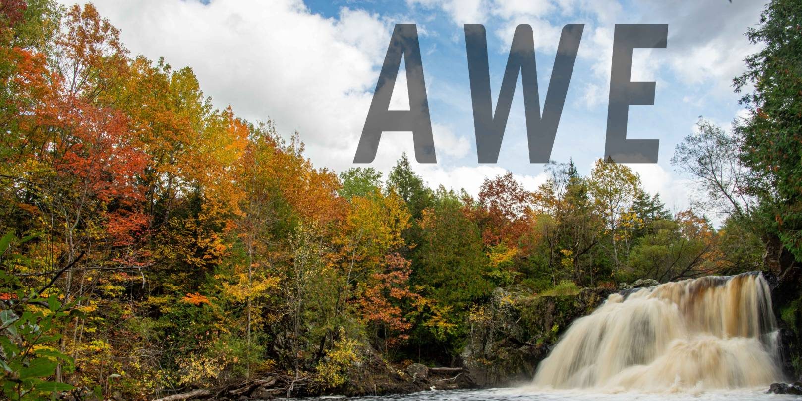 AWE Waterfall and fall foilage. Word "awe" in large letters on it