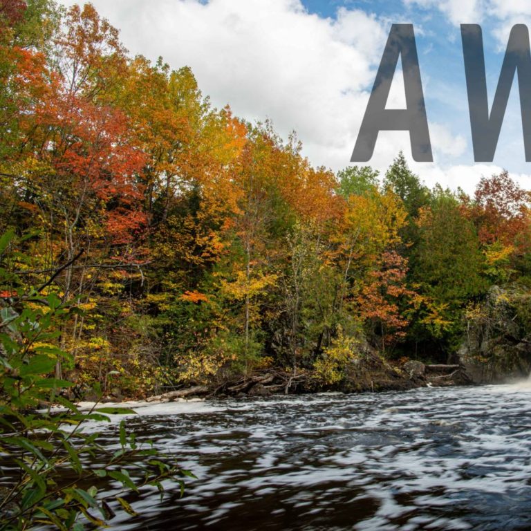 AWE Waterfall and fall foilage. Word "awe" in large letters on it