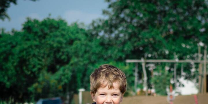 pexels-luna-lovegood-1104007 Young boy smiling and running down dirt road
