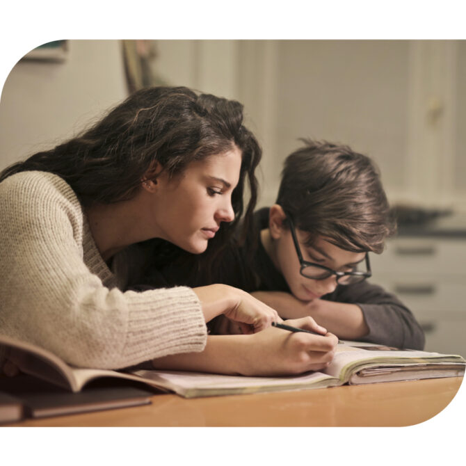 Mom Kid Book Mom looking at book with pre-teen boy