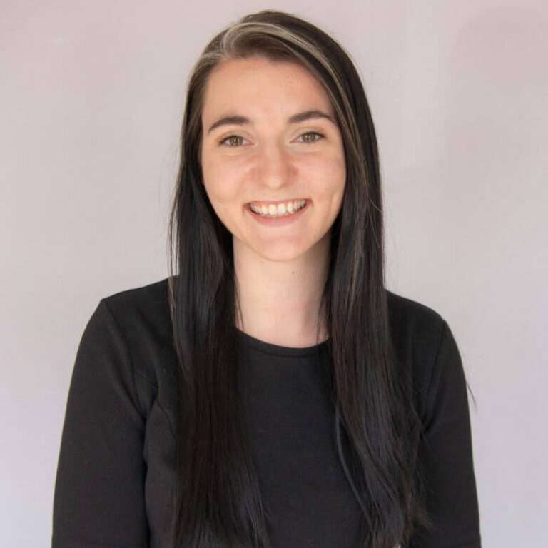Woman smiling with long black hair and black shirt