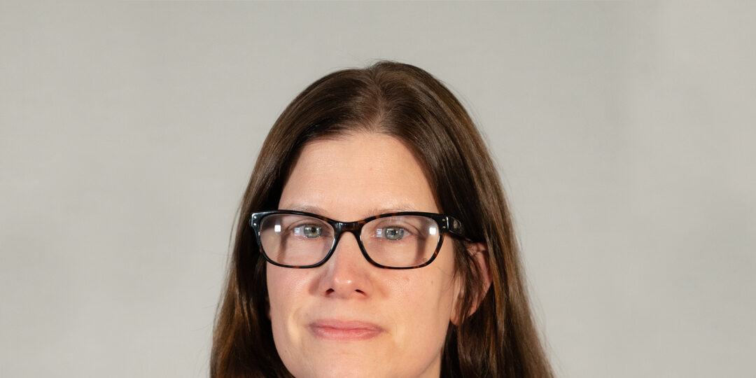 Elizabeth-Kallio-Blog-Photo Headshot of woman with dark brown hair and glasses