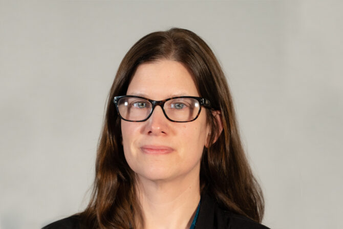 Elizabeth-Kallio-Blog-Photo Headshot of woman with dark brown hair and glasses