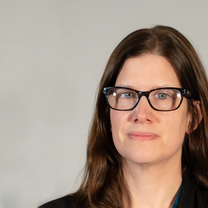 Elizabeth-Kallio-Blog-Photo Headshot of woman with dark brown hair and glasses