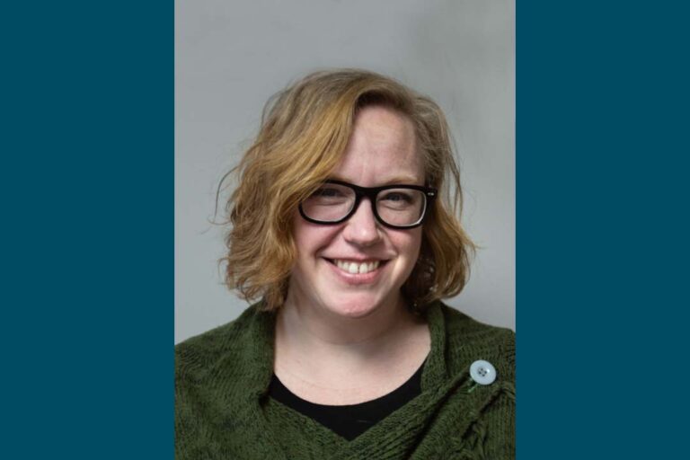 Headshot of woman with black galsses and bob haircut