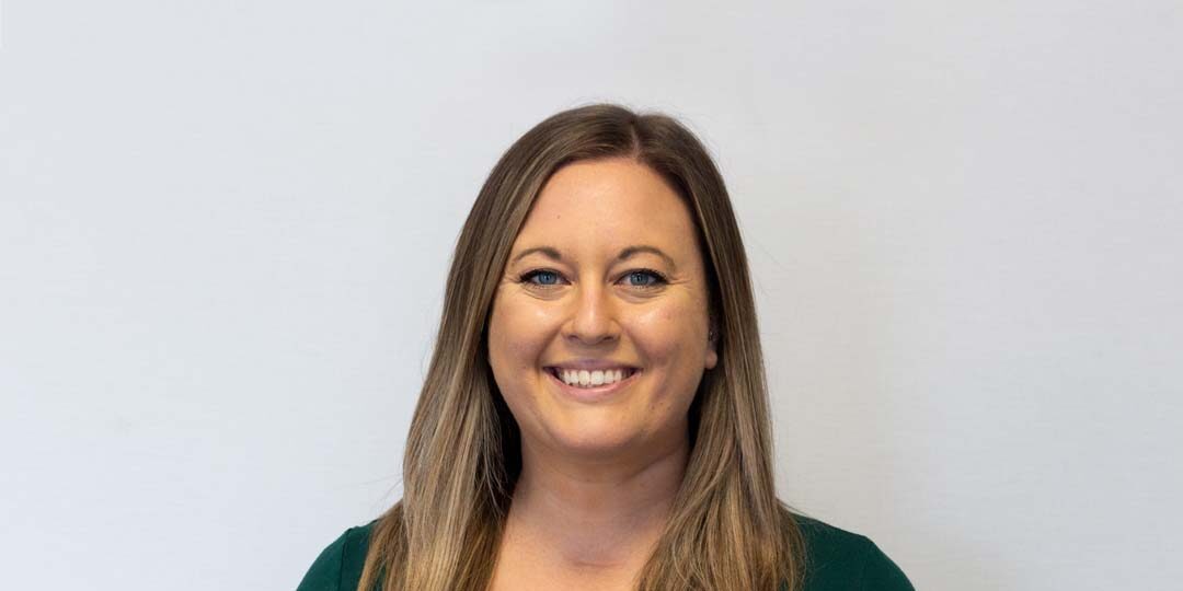 Jordan-Chingo-1080×720 Headshot of woman with long blonde/brown hair and dark green shirt