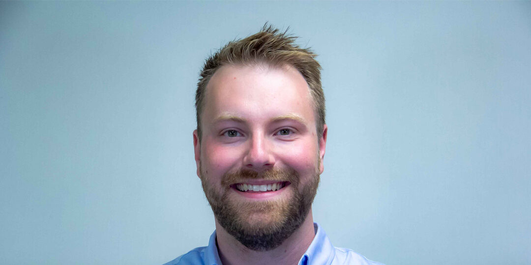 Kyle-Whiteside-Featured-Image Headshot of man with dirty blonde hair and bird in light blue button up