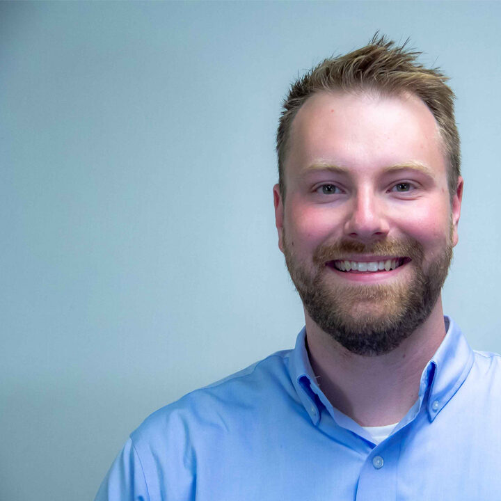 Kyle-Whiteside-Featured-Image Headshot of man with dirty blonde hair and bird in light blue button up