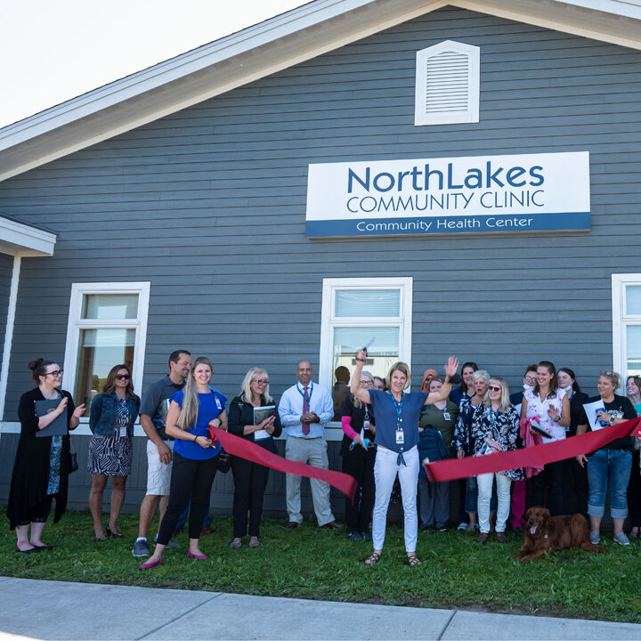 2022-Turtle-Lake-Clinic-Renovation-Celebration-Ribbon-Cutting-Ceremony-Featured-Image Turtle Lake ribbon cutting outside of building and red ribbon