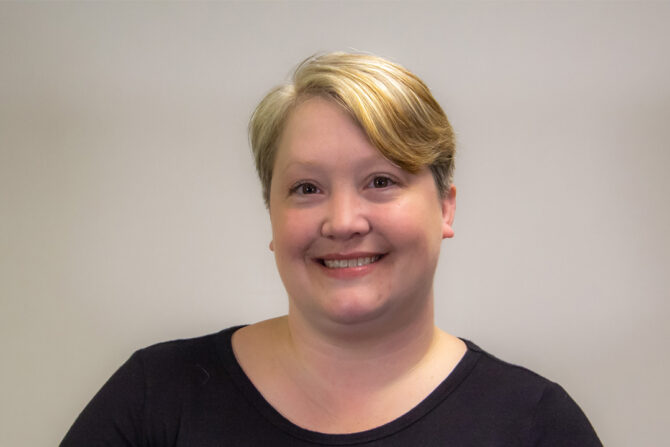 Laura-Buesing-Blog-Post Headshot of woman with blonde ponytail smiling at camera