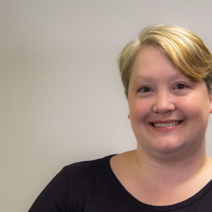 Laura-Buesing-Blog-Post Headshot of woman with blonde ponytail smiling at camera