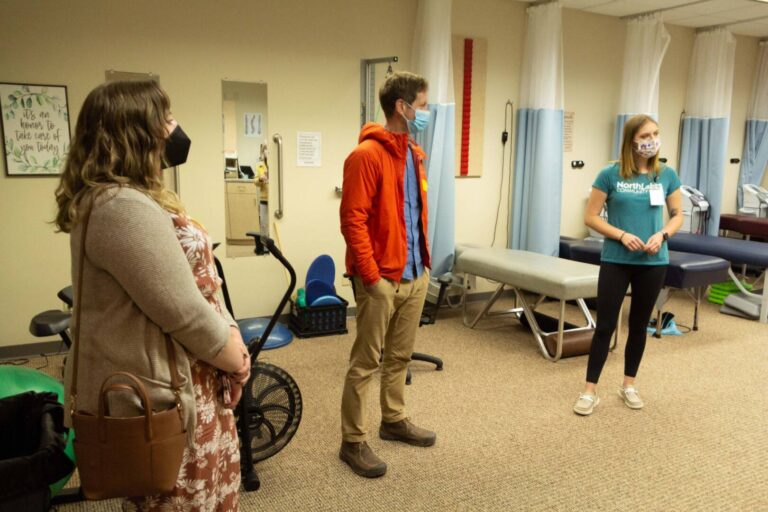 3 people in face masks standing in clinic