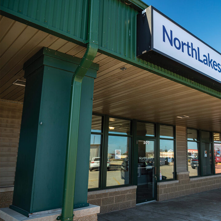 Marinette-Clinic-Featured-Photo Exterior of street mall type of building with NorthLakes Community Clinic sign over it