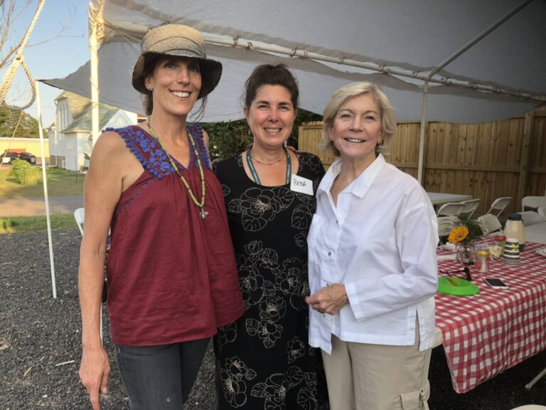 Staff members smiling with Janet Bewley