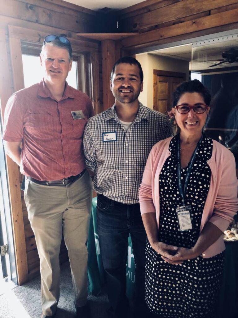 NorthLakes staff smiling and posed with Romaine Quinn