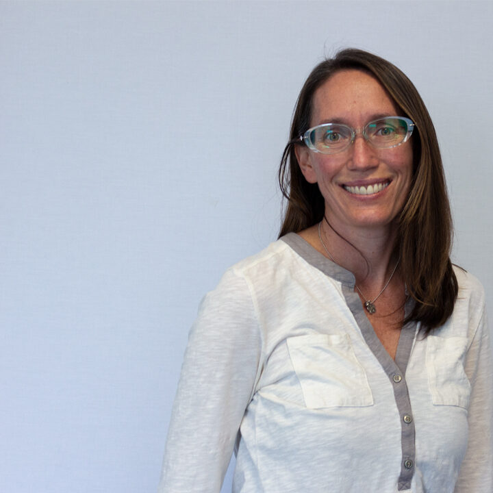 Angela-Vasser-Featured-Blog-Post-Photo Headshot of woman with medium length brown hair and glasses