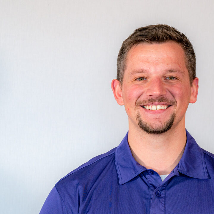 Tanner-Kleppe-Featured-Image-Blog-Post Headshot of man with dark blue shirt and short brown hair