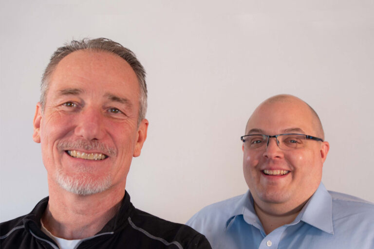 Two men smiling together