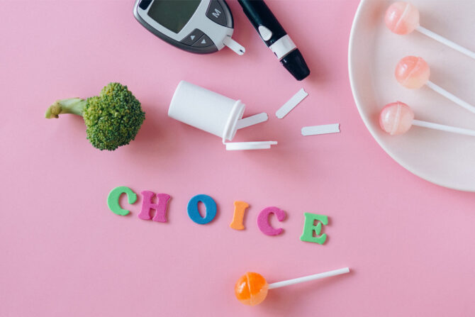 Broccoli, suckers, and glucose monitor on pink background with the word "choice"