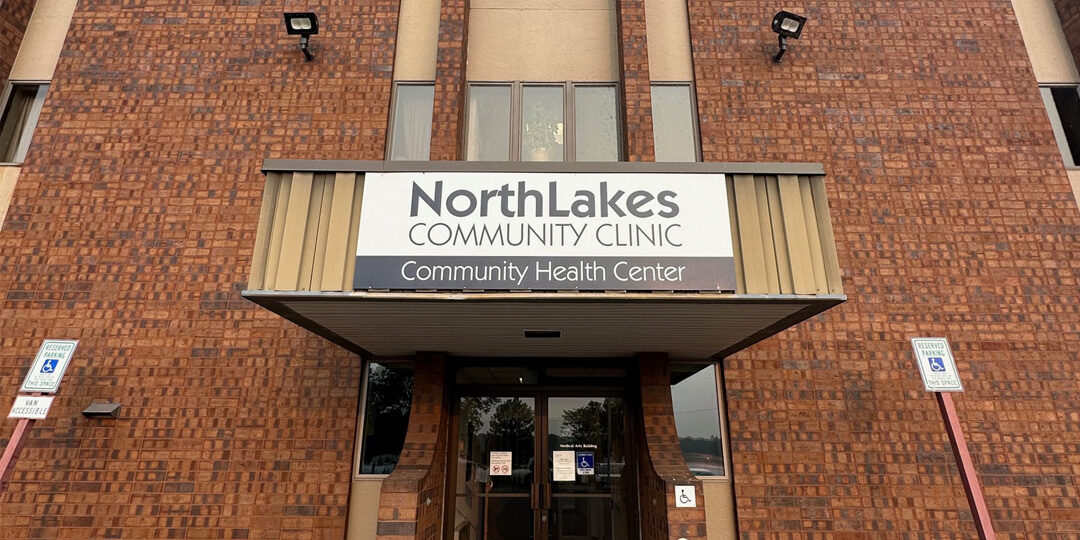 Rice-Lake-Clinic-Now-Offering-Pediatric-Therapies-Featured-Image Outside of brick building with NorthLakes Community Clinic sign on it