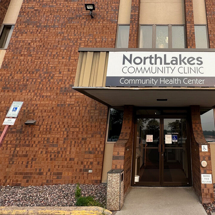 Rice-Lake-Clinic-Now-Offering-Pediatric-Therapies-Featured-Image Outside of brick building with NorthLakes Community Clinic sign on it