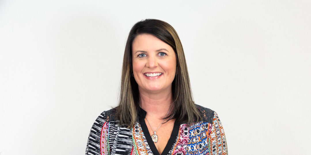 Brenda-Baribeau-Featured-Image Headshot of woman with brown shoulder length hair and patterned top