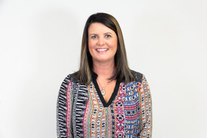 Brenda-Baribeau-Featured-Image Headshot of woman with brown shoulder length hair and patterned top