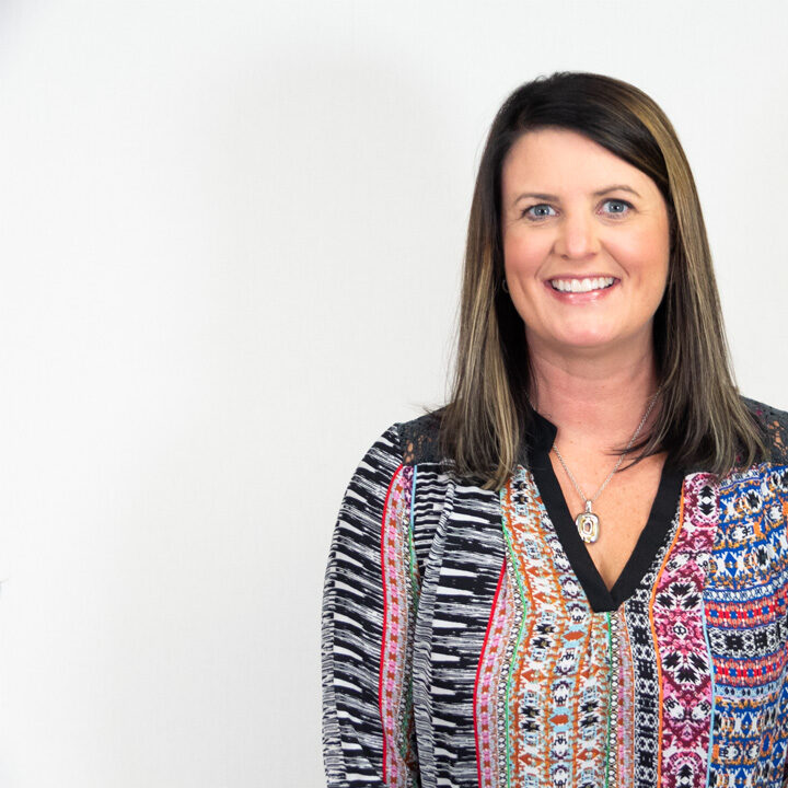 Brenda-Baribeau-Featured-Image Headshot of woman with brown shoulder length hair and patterned top