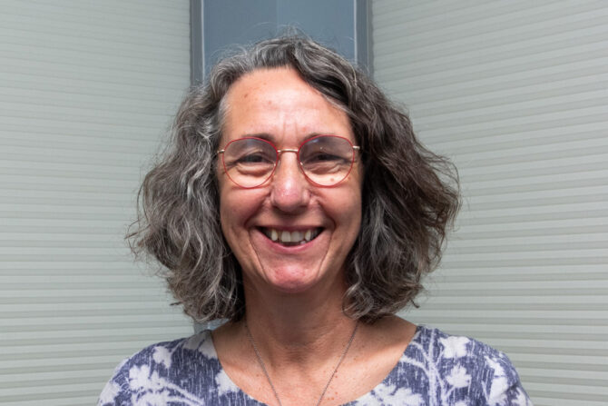 Allison-Allen-Featured-Image headshot of woman with shoulder length gray hair and red framed glasses