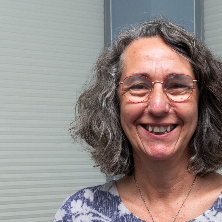 Allison-Allen-Featured-Image headshot of woman with shoulder length gray hair and red framed glasses
