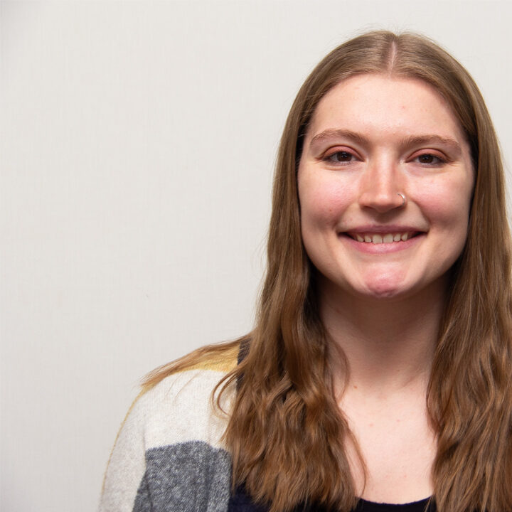 Alayna-Wier-Featured-Image Headshot of woman with long hair smiiling