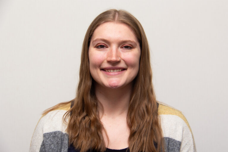 Headshot of woman with long hair smiiling