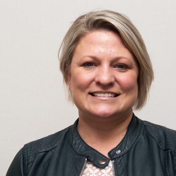 Christi-Fowler-Featured-Image Woman with black leather jacket and short blonde hair