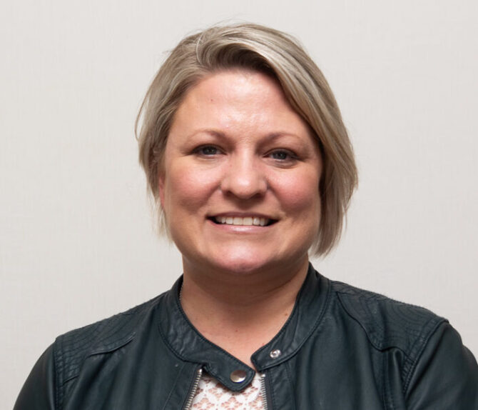 Christi-Fowler-Featured-Image Woman with black leather jacket and short blonde hair