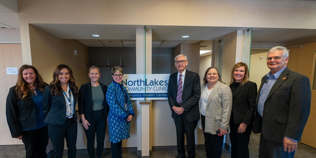 Gov-Evers-Visit-Eau-Claire-Clinic-on-Clairemont-Ave-Featured-Image Group of people including Tony Evers smiling and posing for the camera