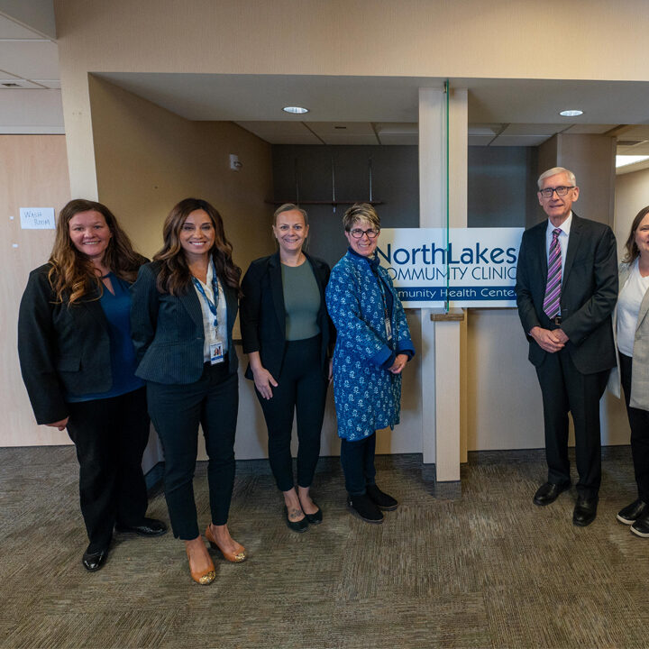 Gov-Evers-Visit-Eau-Claire-Clinic-on-Clairemont-Ave-Featured-Image Group of people including Tony Evers smiling and posing for the camera